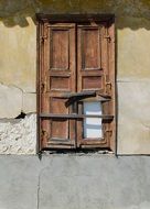 wooden window on the facade of a dilapidated building