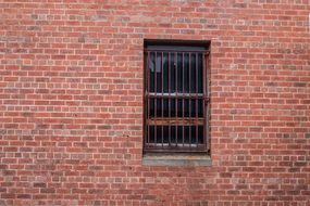 brick wall and window with bars