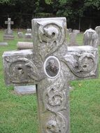 stone cross with a photograph in the cemetery
