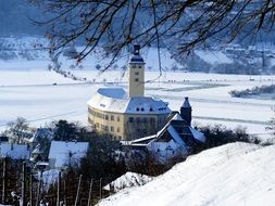 building with tower in countryside at winter