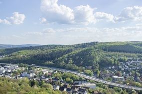 panoramic view of the cityscape among green hills