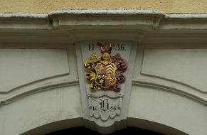 coat of arms on the facade of the building in the city of Freiberg