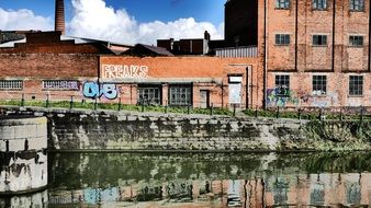 cityscape of grunge brick industrial Buildings in front of water in belgium, Ghent