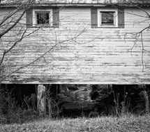 Black and white photo of a rural wooden shack