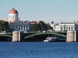 Large Bridge over the blue river and beautiful buildings on the shore