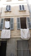 old mediterranean street with clotheslines on the windows