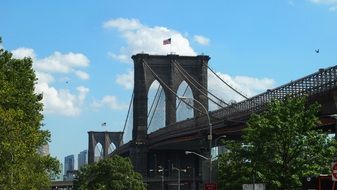 flag on top of brooklyn bridge