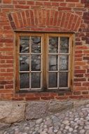 wooden window in a brick castle