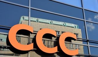 glass facade building mirroring on glass facade with lettering