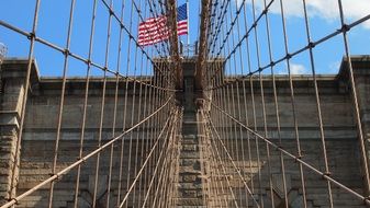 america flag on brooklyn bridge metal grid