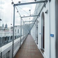 glass covered walkway along wall of building