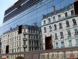 reflection of the old town on the glass modern building in Lyon