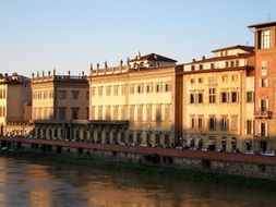 houses near the river at dusk in florence