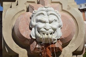 Gargoyle face like a fountain in Seville, Spain