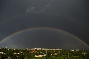 rainbow over the city in the dark sky on panorama in Kharkov, Ukraine