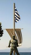 sculpture of a sailor near the flag