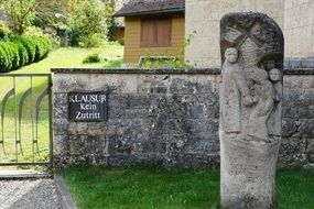 stone monument in front of fence of Catholic Church, germany, Beuron