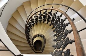 spiral staircase with wrought iron railing