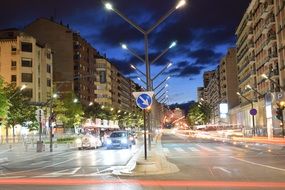 panorama of city traffic lights among the buildings on the street