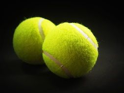 fabric tennis balls on a black background