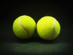 hairy tennis balls on a dark background