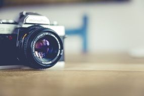 photo camera on a wooden surface