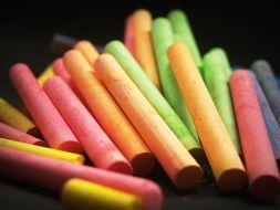 colored chalk on a black surface