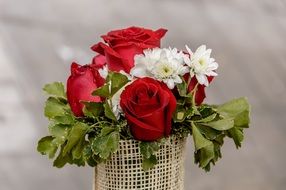 bouquet of flowers in a basket close-up on blurred background