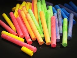 crayons lie on a black surface