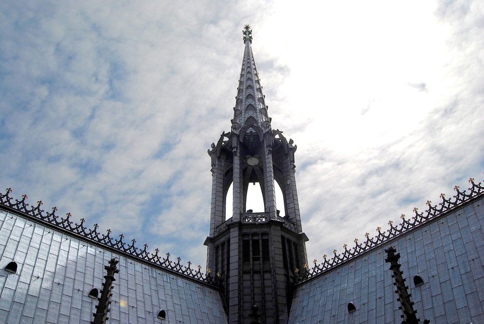 Spire of the Mid Tower under the white clouds