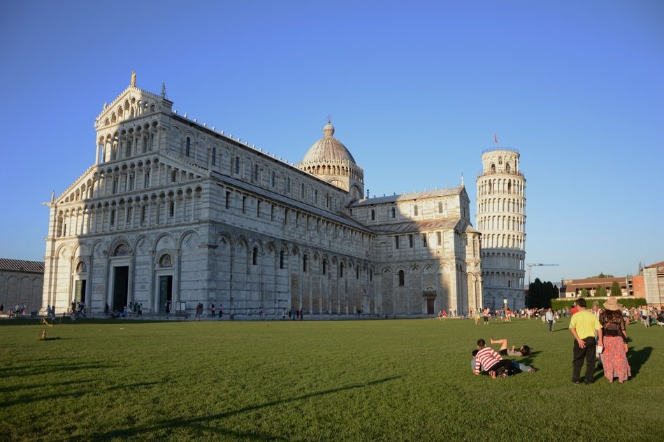 people rest on lawn at cathedral, Italy, pizza