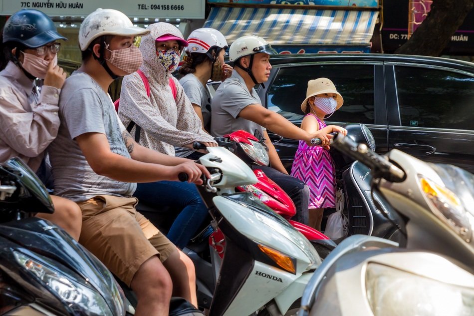 people in Safety Helmets on Scooters in traffic, vietnam, hanoi