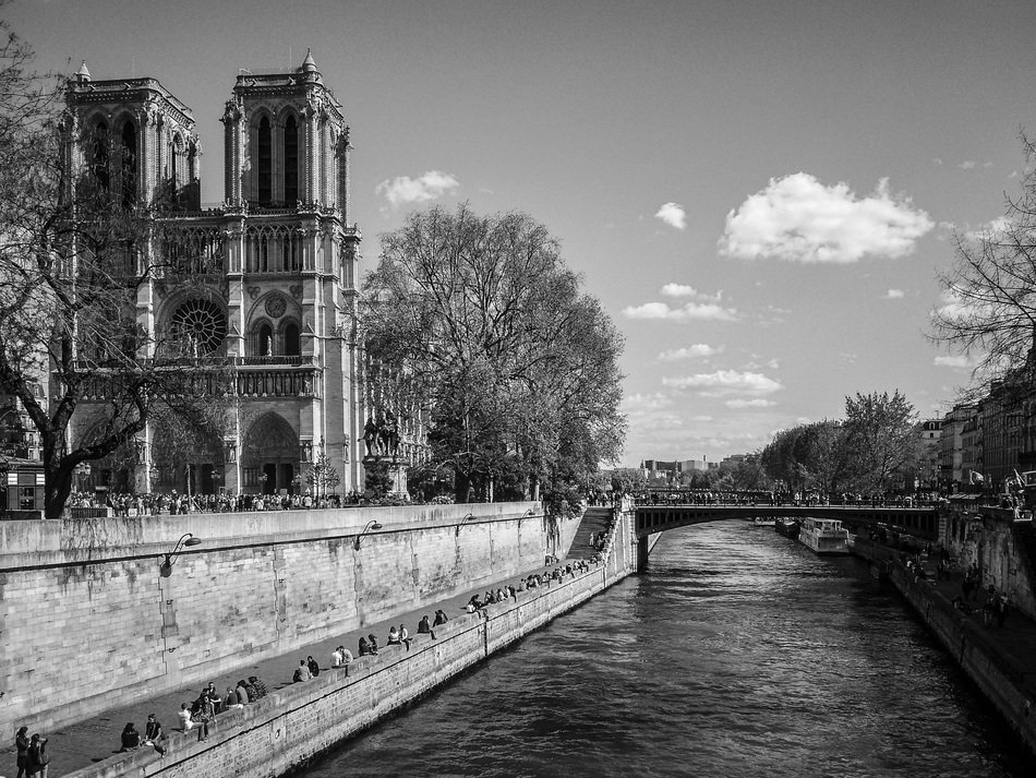 black and white photo of Notre Dame de Paris view from the waterfront