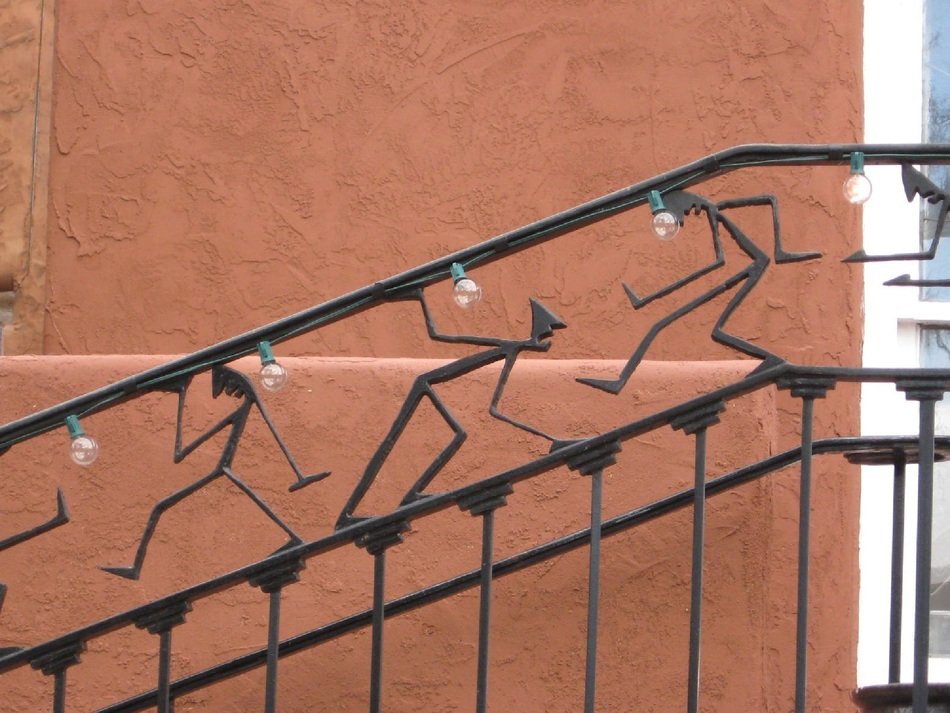the black pieces in the form of people decorate the railings