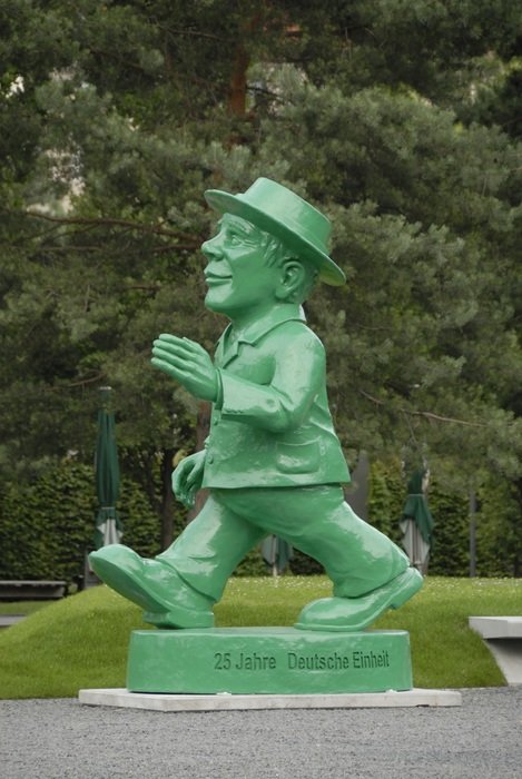statue of a walking man in the park