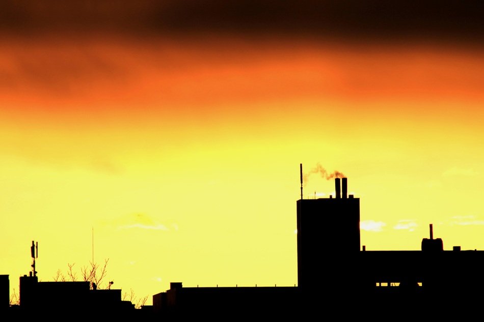 silhouettes of city buildings during sunrise