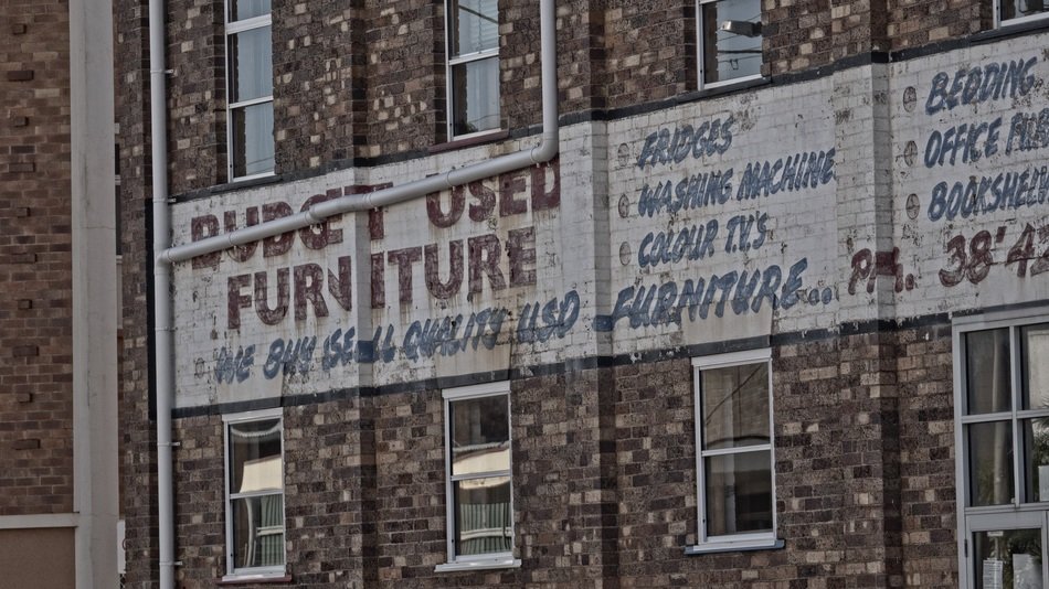 poster on the wall of a city building