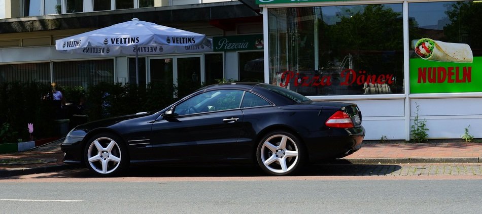 black car near italian pizzeria