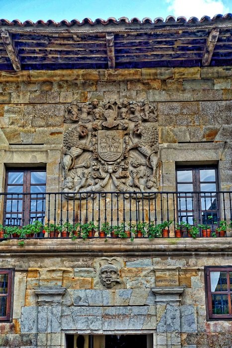 balcony with flowers of an old stone building