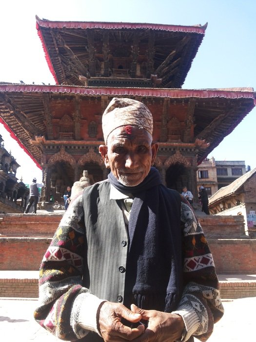 man near a temple in Nepal