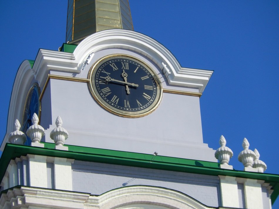 clock on the bell tower on a sunny day