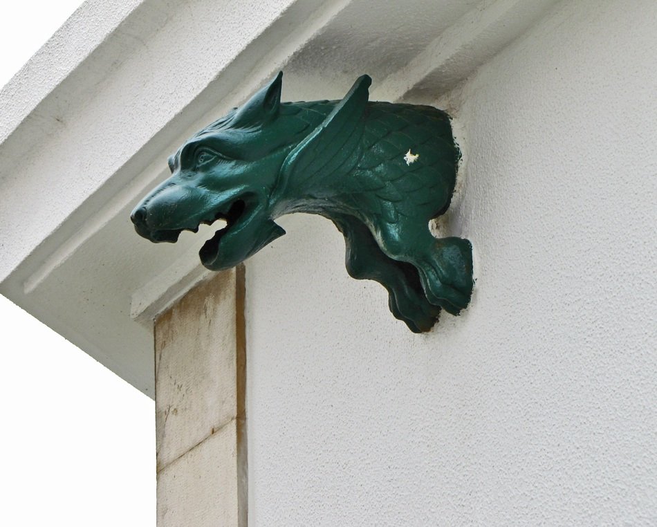 green chimera on a building wall