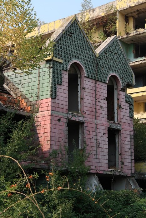 damage to the building among the greenery in bosnia