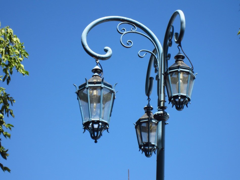 Beautiful iron street lanterns against the blue sky
