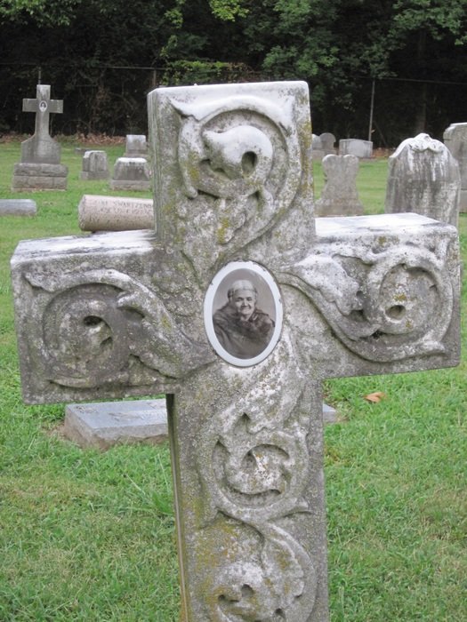 stone cross with a photograph in the cemetery