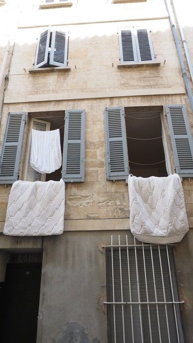 old mediterranean street with clotheslines on the windows