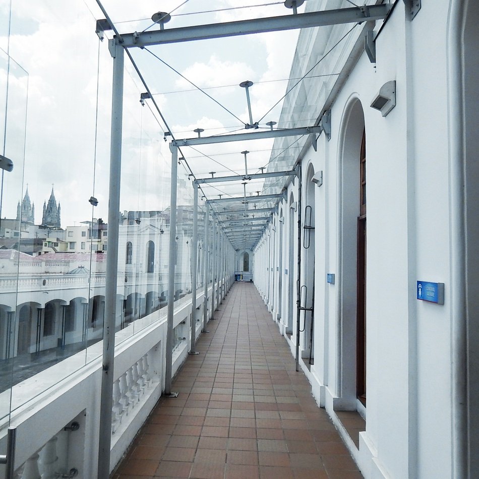 glass covered walkway along wall of building