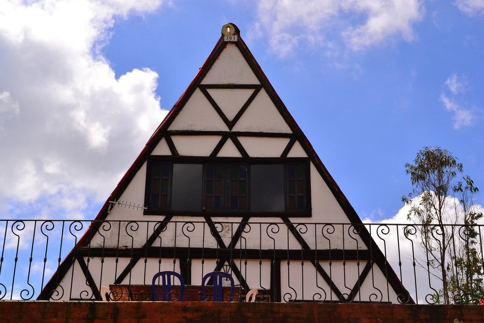 timber framed gable roof behind fence