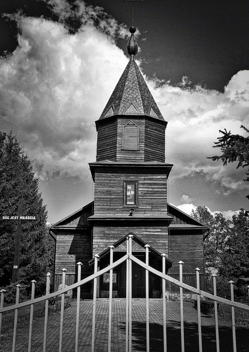 black and white photo of the church behind the fence