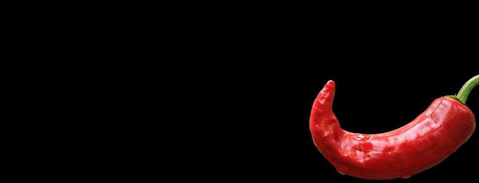 red pepperoni on a black background